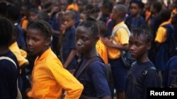 FILE - Students arrive for class at the Every Nation Academy private school in the city of Makeni in Sierra Leone.