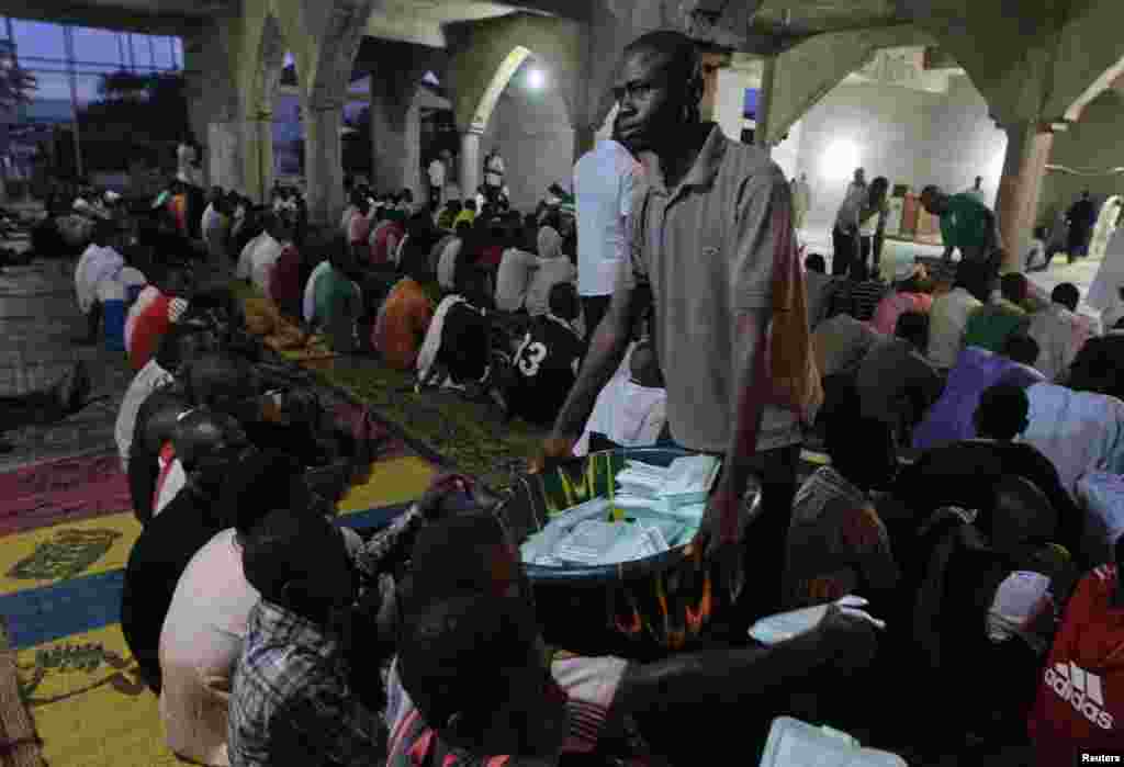 A man serves food during the Islamic holy month of Ramadan at Nasfat Mosque in Utako, Abuja.