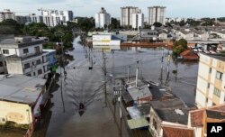 A boat navigates through a flooded street after heavy rain in Canoas, Rio Grande do Sul state, Brazil, May 8, 2024.