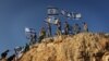 Children in the West Bank settlement of Itamar wave Israeli flags on a hilltop, Sept. 20, 2012. (VOA/Rebecca Collard)