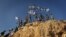 Children in the West Bank settlement of Itamar wave Israeli flags on a hilltop, Sept. 20, 2012. (VOA/Rebecca Collard)