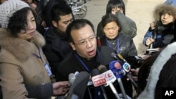 FILE - In this Jan. 22, 2009 file photo, Zhao Lianhai, center, the father of a girl sickened after she drank tainted milk formula, speaks to journalists outside the Intermediate People's Court in Shijiazhuang, in China's Hebei province. Zhao, the Chinese 