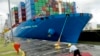 FILE - A Panama Canal worker sweeps a red carpet after it rained moments before the arrival of China's President Xi Jinping and Panama's President Juan Carlos Varela, where they will post for an official photo at Cocoli Locks inside the Panama Canal in Panama City, Dec. 3, 2018.