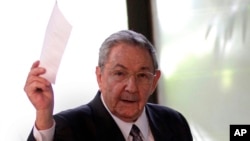 Cuba's President Raul Castro holds up the ballot of his brother Fidel, also present in the session, for president of the National Assembly during the opening session of the parliament in Havana, Cuba, Feb. 24, 2012. 
