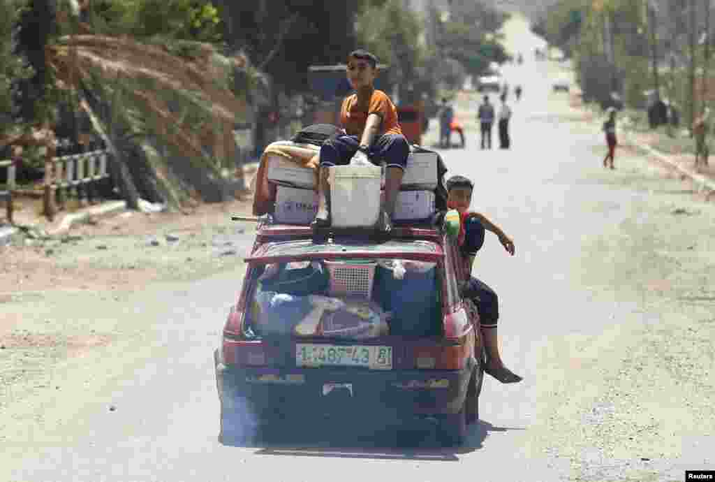 Palestinians returning to their house during a 72-hour truce in Beit Hanoun town, which was heavily hit by Israeli shelling and air strikes during the Israeli offensive, in the northern Gaza Strip, Aug. 11, 2014.