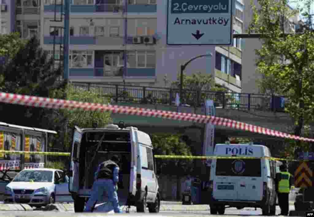 Forensic experts work at the scene after a bomb exploded at a bus stop during rush hour in Istanbul, Turkey, Thursday, May 26, 2011. A bomb placed on a bicycle near a bus stop exploded during morning rush hour in Istanbul on Thursday, injuring seven peopl