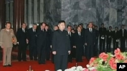 In this image made from KRT television, Kim Jong Un, center, North Korean leader Kim Jong Il's youngest known son and successor, visits the body of senior Kim in a memorial palace in Pyongyang, North Korea, December 20, 2011.