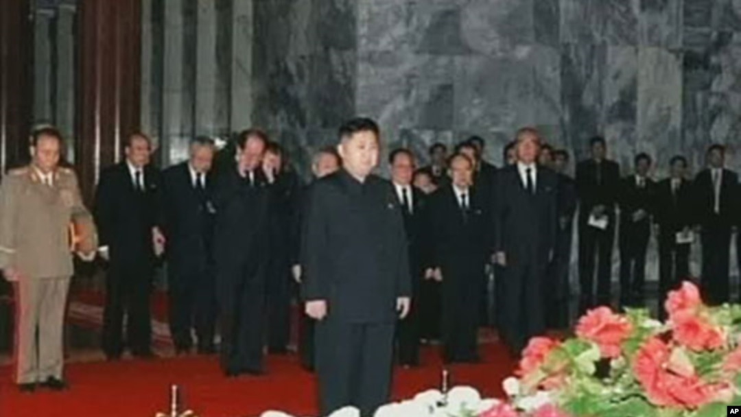 In this image made from KRT television, Kim Jong Un, center, North Korean leader Kim Jong Il's youngest known son and successor, visits the body of senior Kim in a memorial palace in Pyongyang, North Korea, December 20, 2011.