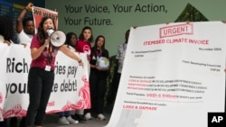 FILE - Activist Teresa Anderson leads a objection  calling for clime  concern   during the COP29 U.N. Climate Summit, Nov. 14, 2024, successful  Baku, Azerbaijan.