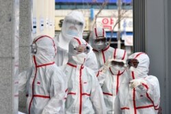 Medical staff members in protective gears arrive for a duty shift at Dongsan Hospital in Daegu, South Korea, March 3, 2020.