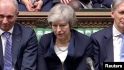 Prime Minister Theresa May sits down in Parliament after the vote on May's Brexit deal, in London, Britain, Jan. 15, 2019 in this image taken from video.