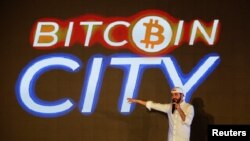 FILE - El Salvador's President Nayib Bukele speaks at the closing party of “Bitcoin Week,” where he announced the plan to build the first "Bitcoin City" in the world, in Teotepeque, El Salvador, Nov. 20, 2021. 