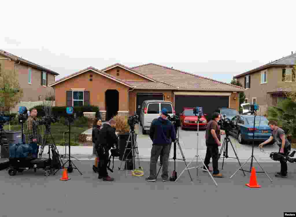 Members of the news media stand outside the home of David Allen Turpin and Louise Ann Turpin in Perris, California, Jan. 15, 2018. Authorities said the couple were arrested for keeping their 13 children captive in their home in filthy conditions.