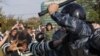 Russia Opens Probe into Beating of Female Protester
