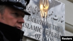 FILE - A police officer stands on duty outside the Iranian embassy in Kensington, central London December 2, 2011.