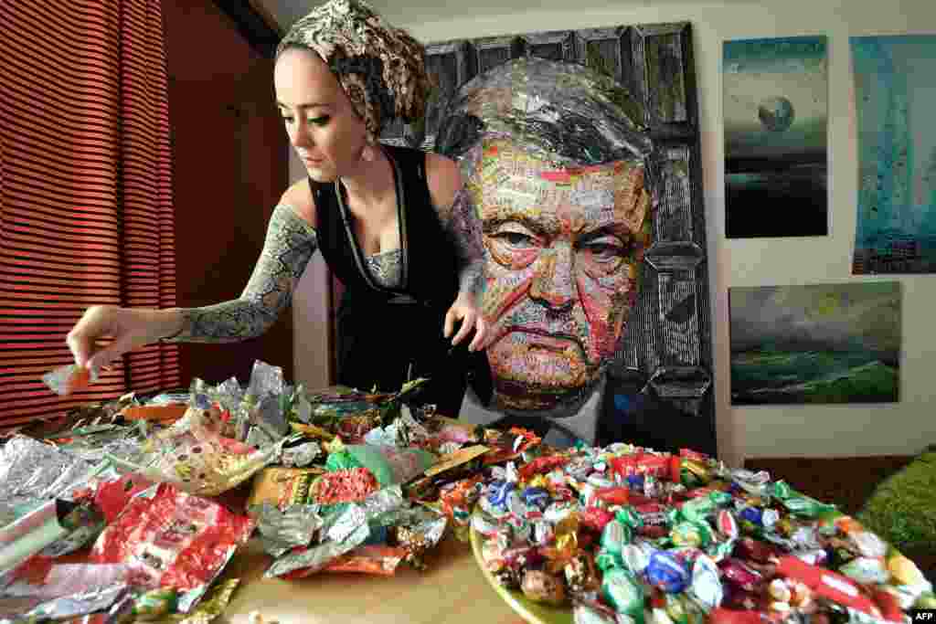 Ukrainian artist Daria Marchenko creates a large-scale artwork entitled &#39;The Face of Corruption&#39; depicting President Petro Poroshenko, made with sweet wrappers of Roshen, the Poroshenko&#39;s confectionery company, in her workshop in Kiyev, March 28, 2019, ahead of the March 31 presidential elections.
