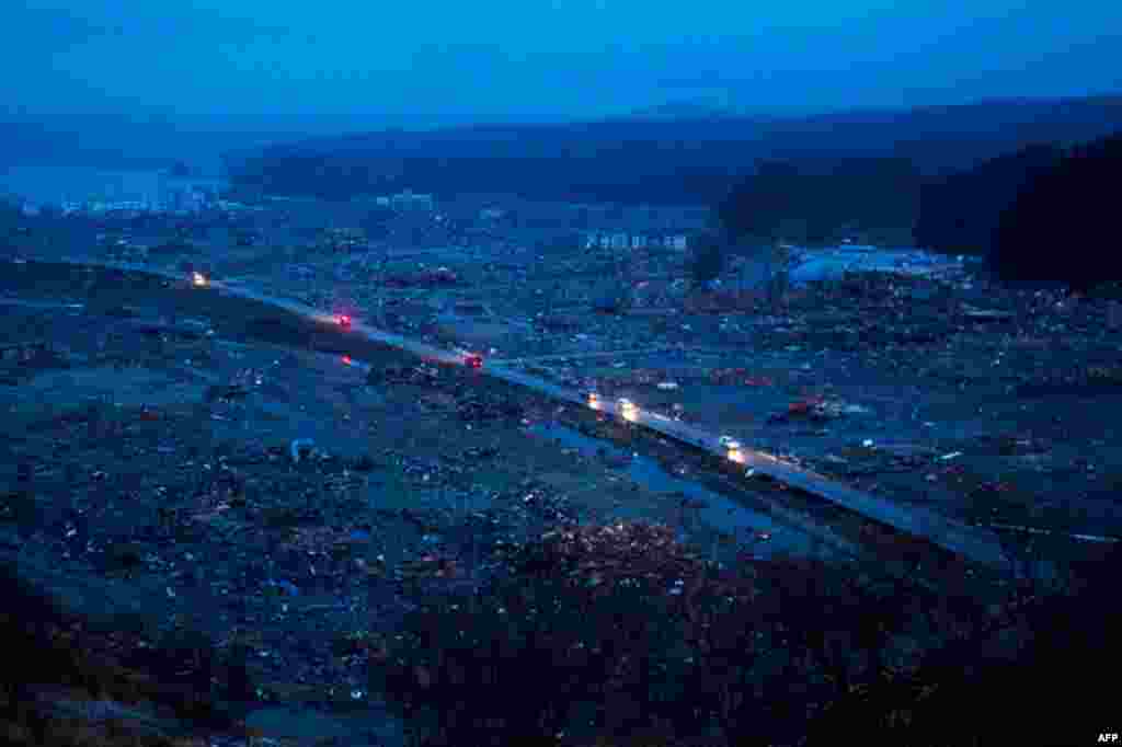 Japanese vehicles pass through the ruins of the leveled city of Minamisanriku, northeastern Japan, Tuesday March 15. (AP)