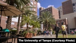 Students walk across campus at the University of Tampa in Tampa, Florida.