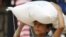  A boy carries food aid given by UN's World Food Programme in Raqqa, Syria April 26, 2018. REUTERS/Aboud Hamam/File Photo