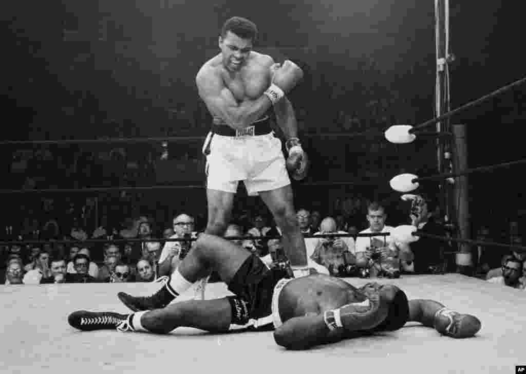 FILE - Heavyweight champion Muhammad Ali stands over fallen challenger Sonny Liston, shouting and gesturing shortly after dropping Liston with a short hard right to the jaw, in Lewiston, Maine, May 25, 1965.