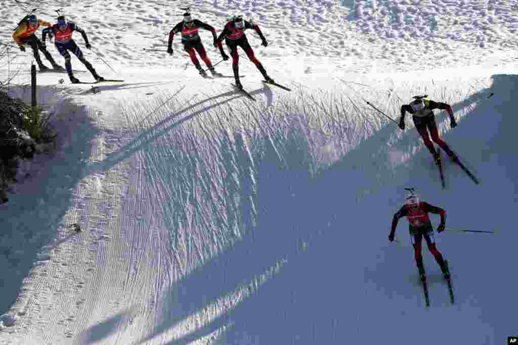 Johannes Dale of Norway, foreground right, Johannes Thingnes Boe of Norway, top right, Tarjei Boe of Norway, 3rd right, Sturla Holm Laegreid of Norway, 3rd left, Lukas Hofer of Italy, 2nd left, and Erik Lesser of Germany compete during the men&#39;s 15 km mass start race at the Biathlon World Cup in Hochfilzen, Austria.&nbsp;