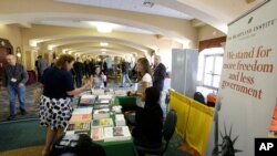 Delegates stop by one of the many information booths at the National Libertarian Party Convention in Orlando, Fla., May 27, 2016.