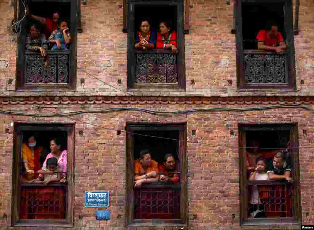 People observe the Nil Barahi mask dance festival, a yearly event during which dancers perform while acting as several gods that people worship to seek blessings, in Bode, Nepal.