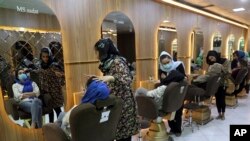 Beauticians put makeup on customers at Ms. Sadat’s Beauty Salon in Kabul, Afghanistan, Sunday, April 25, 2021. Kabul's young working women say they fear their dreams may be short-lived if the Taliban return to Kabul, even if peacefully as part of a new go