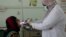 Nahla Arishi, a pediatrician, checks a woman infected with diphtheria at the al-Sadaqa teaching hospital in the southern port city of Aden, Yemen, Dec. 18, 2017. 