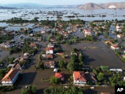 FILE - Floodwaters and mud cover the town of Palamas, after the country's rainstorm record, in Karditsa, Thessaly region, central Greece, Sept. 8, 2023.