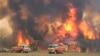 In this image dated Dec. 30, 2019, and provided by NSW Rural Fire Service via their twitter account, firefighters are seen as they try to protect homes around Charmhaven, New South Wales. Wildfires burning across Australia's two most-populous states…