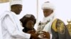 The new Sultan of Sokoto, Saad Abubakar,(C) the spiritual leader of Nigeria's Muslims, receives a copy of the Qura'an from Sokoto state governor Atahiru Bafarawa, during a coronation ceremony in Sokoto March 3, 2007.