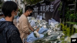 Flowers are placed outside the liaison office for the late former Chinese President Jiang Zemin in Hong Kong, Dec. 6, 2022.