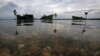 FILE - Decaying wrecks of confiscated foreign trawlers rot in a shallow estuary near Penagi on Natuna Besar.