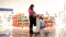 FILE - A woman from China at a duty-free store that offers new Mandarin-speaking personal shopper service at the airport in Frankfurt, Germany, Nov. 14, 2012.