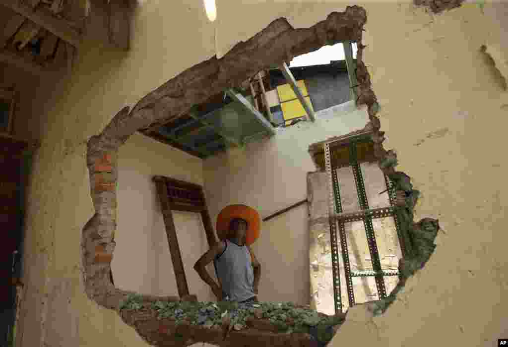 A man inspects his house ahead of an eviction by the government in Jakarta, Indonesia.