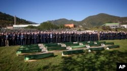 Imams and mourners attend the collective funeral for 19 victims of a landslide caused by recent floods in Jablanica, Bosnia, Oct. 15, 2024.