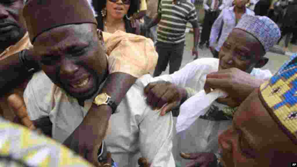 An unidentified family member of Maj. Hamza Al-Mustapha cries after a court Verdict in Lagos, Jan. 30, 2012.