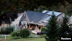 A home sits collapsed where a man died during a series of gas explosions in Lawrence, Mass., Sept. 14, 2018.