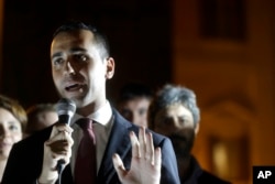 FILE - 5-Star Movement lawmaker Luigi Di Maio talks during a protest outside the Italian Parliament, in Rome, Oct. 12, 2017.