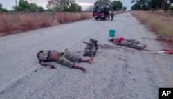 FILE - In this image made from video, the bodies of dead militants are seen on a road on the outskirts of Mocimboa Da Praia, in Cabo Delgado province, Mozambique, Wednesday, Aug. 11, 2021.