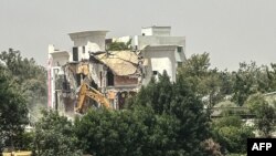 TOPSHOT - Heavy machinery tear down the headquartersof the Chadian opposition Party Without Borders in N'djamena on March 1, 2024. A cousin of Chad's transitional president Mahamat Idriss Deby Itno died in a battle with troops that his party said was an "assassination." 