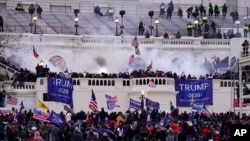 FILE - In this Wednesday, Jan. 6, 2021, file photo, rioters storm the Capitol, in Washington. Capitol Police say they have intelligence showing a “possible plot” by a militia group to breach the U.S. Capitol on Thursday, nearly two months after a…