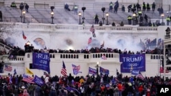 FILE - Rioters storm the Capitol, in Washington, Jan. 6, 2021.