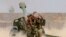Fighters take a selfie while firing artillery against Islamic State militants in Fallujah, Iraq on Sunday, May 29, 2016.