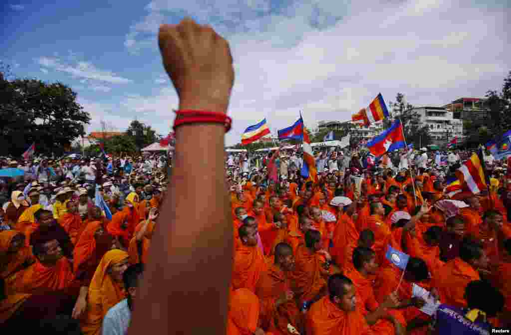 Buddhist monks who are supporters of the Cambodia National Rescue Party (CNRP), react during a protest as party leader Sam Rainsy announces the result of a meeting with Cambodian Prime Minister Hun Sen, at Freedom Park in Phnom Penh.
