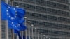 FILE - European Union flags set of half staff outside the European Commission headquarters in Brussels, Belgium.