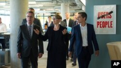German Interior Minister Thomas de Maiziere; Eva- Maria Kirschsieper, Facebook head of public policy; and Martin Ott, Facebook managing director central Europe, from left, walk during a visit at the Facebook office in Berlin, Germany, Aug. 29, 2016. 