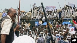 Sudan's President Omar Al Bashir (L) waves to supporters during a visit to Osaef town in Sudan's Red Sea state, June 20, 2011