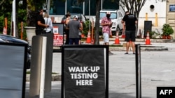 People line up at a walk-up COVID-19 testing site in Miami Beach, Florida on November 17, 2020.